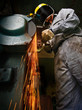 Photo: Tradesman at work grinding steel. Tradesman at work grinding steel.