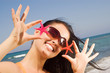 oung beautiful woman holding two starfish at the seaside