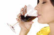 Beautiful brunet girl drinking red wine isolated