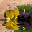 Massage oils and candle with green grass