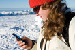 Female skier writing message from her cell phone