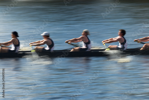 Photo: Teamwork, rowers in a rowing boat pulling in harmony Teamwork, rowers in a rowing boat pulling in harmony