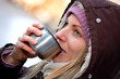 young female drinking hot tea in winter