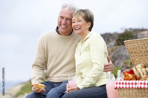Photo: Couple Eating An Al Fresco Meal At The Beach Couple Eating An Al Fresco Meal At The Beach