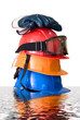 Many colored hardhats, gloves and goggles