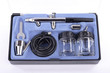 Airbrush and accessories in display box on white