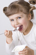 Cute girl eating yogurt Cute girl eating yogurt