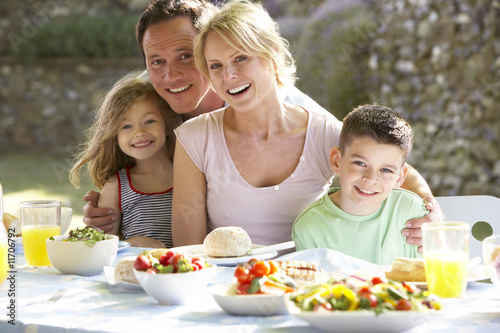 Photo: Family Eating An Al Fresco Meal Family Eating An Al Fresco Meal