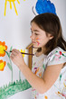 Young girl painting on wall