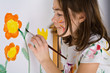 Young girl painting on wall