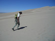 Man hiking in sand dunes