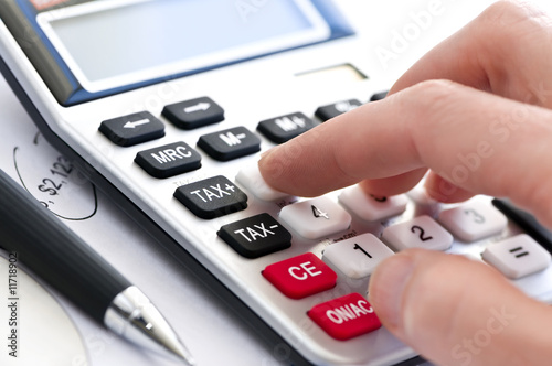 Photo: Tax calculator and pen Tax calculator and pen