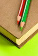 book and crayons on green