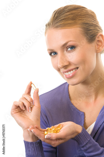 Photo: Young happy woman with Omega 3 fish oil capsula, isolated Young happy woman with Omega 3 fish oil capsula, isolated