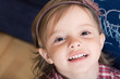 Portrait of a joyful little girl with sketched blackboard