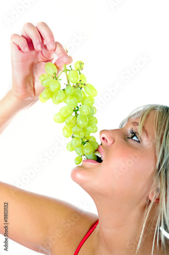 Photo: Pretty Blond eating a bunch green grapes Pretty Blond eating a bunch green grapes