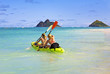 two sisters paddling a kayak in Hawaii two sisters paddling a kayak in Hawaii