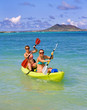 Two sisters paddling a kayak in Hawaii