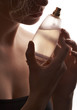 sensual woman smelling perfume, golden perfume bottle sensual woman smelling perfume, golden perfume bottle