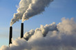 steam rise from smokestacks at an electrical generating plant