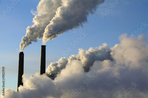 Photo: steam rise from smokestacks at an electrical generating plant steam rise from smokestacks at an electrical generating plant