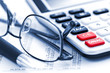 Photo: Tax calculator pen and glasses Tax calculator pen and glasses