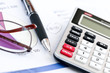 Tax calculator pen and glasses Tax calculator pen and glasses