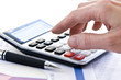 Photo: Tax calculator and pen Tax calculator and pen