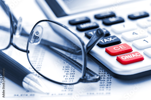 Photo: Tax calculator pen and glasses Tax calculator pen and glasses