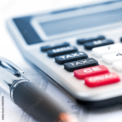 Photo: Tax calculator and pen Tax calculator and pen