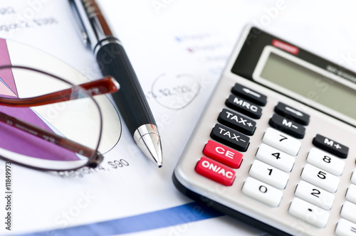 Photo: Tax calculator pen and glasses Tax calculator pen and glasses