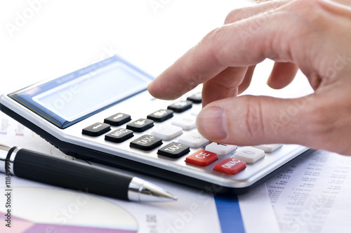 Photo: Tax calculator and pen Tax calculator and pen