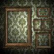 vintage grunge wall bacground with empty gold paiting frame