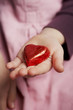 Photo: child presenting a red candy heart child presenting a red candy heart