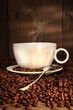 White coffee cup with spoon on roasted beans White coffee cup with spoon on roasted beans