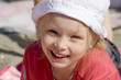 Smiling cheerful girl on the beach
