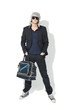 Photo: young man wearing suit and holding traveling bag young man wearing suit and holding traveling bag