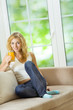 Young woman drinking orange juice at home