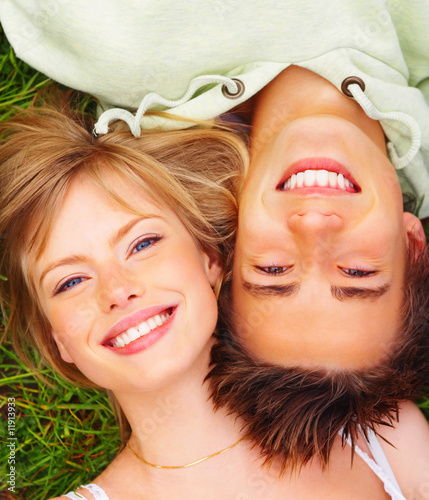 Photo: A happy couple lying on grass A happy couple lying on grass