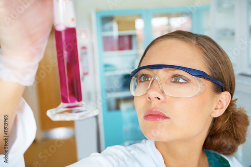 Female researcher holding up a test tube