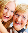 Foto: A young woman hugs an older happy elderly woman A young woman hugs an older happy elderly woman