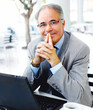 Middle-aged business man in suit with a laptop