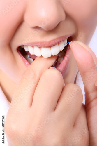 Photo: Woman Flossing Her Teeth Woman Flossing Her Teeth