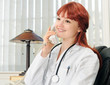 Young female doctor calling on phone, smiling. Young female doctor calling on phone, smiling.