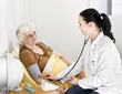 Photo: Senior lady having his blood pressure checked by a doctor Senior lady having his blood pressure checked by a doctor
