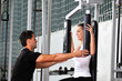 woman in the fitness gim working out with personal trainer