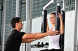 woman in the fitness gim working out with personal trainer