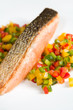 grilled salmon with vegetables over white dish