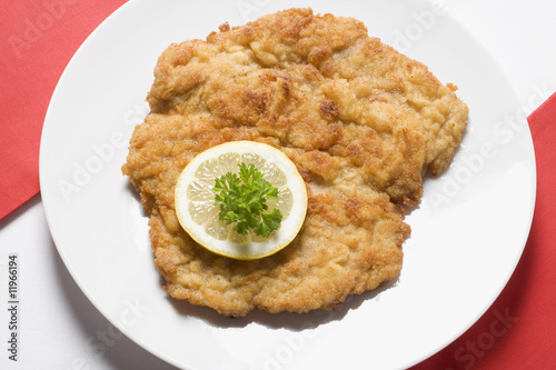 Photo: wiener schnitzel (veal escalope) with lemon slice & parsley wiener schnitzel (veal escalope) with lemon slice & parsley