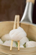 dim sum on chopsticks and in bamboo steamer